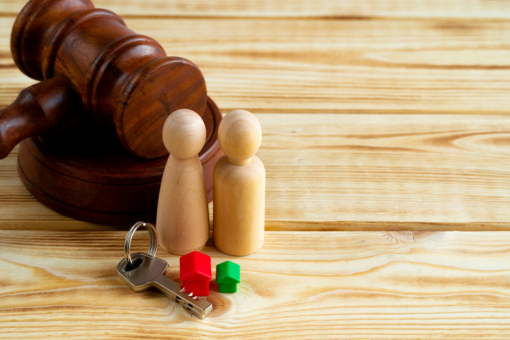 Divorse property division concept. Wooden family with house and judge gavel